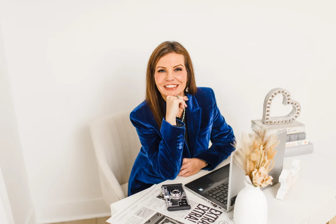 Carolyn Eichenhofer working at her laptop in a blue blazer